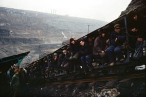 Men sitting on structure outside