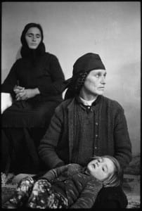 Two women in traditional dress looking away from camera