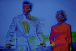 Man in blue and woman in red distorted by blue filter