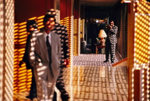 Hotel hallway with sunlight streaming through window creating pattern on wall