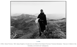 Young man in long robes walking along mountain path