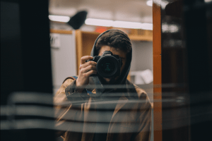 Author behind camera taking a photo of a mirror