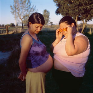 Two women with stomachs touching