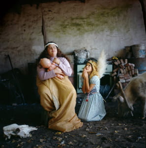 two young girls posed as virgin mary with child and angel.