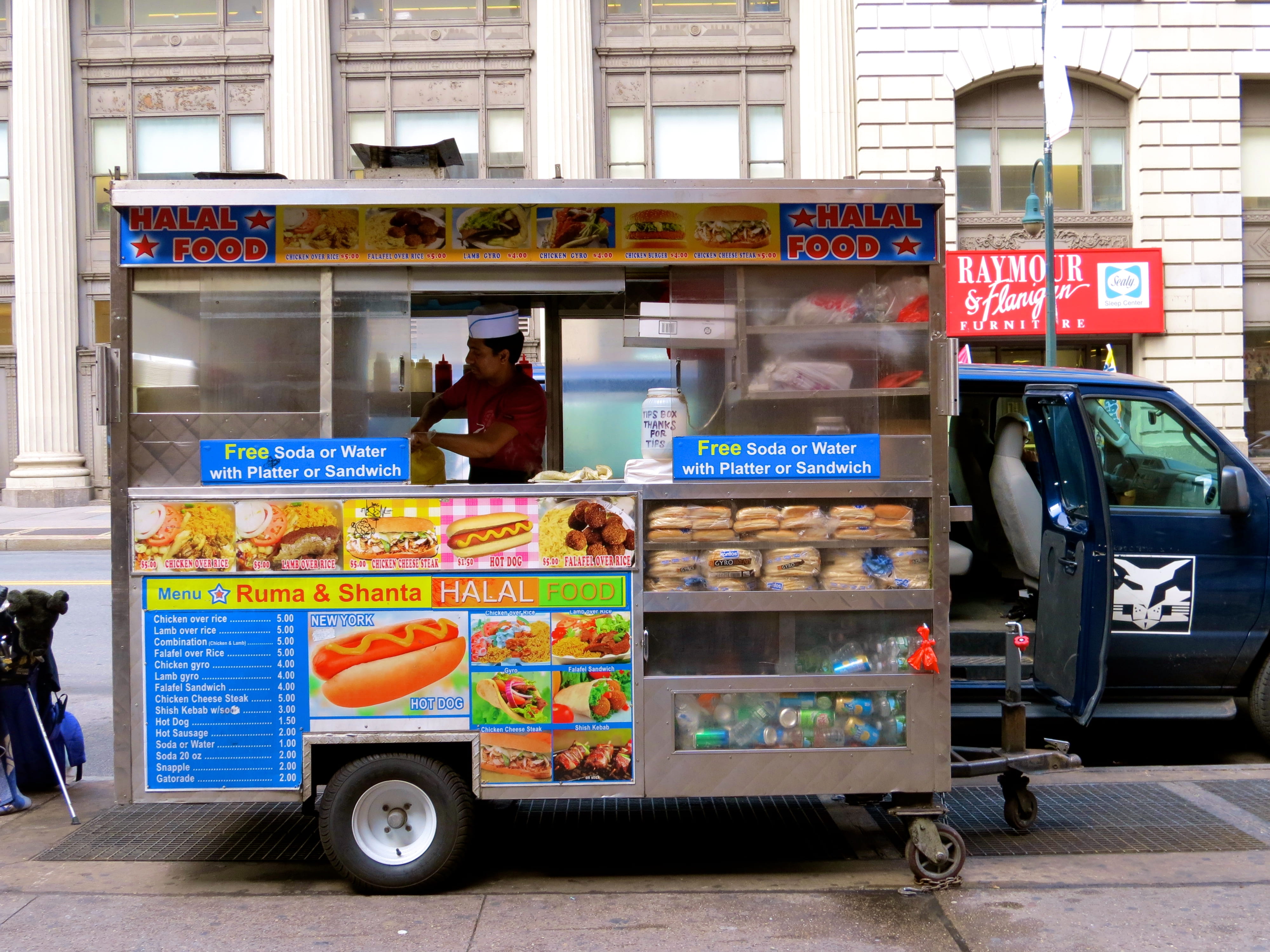 Halal truck with man inside cooking