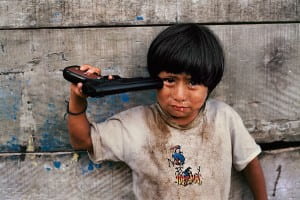 Young boy holding gun to his head