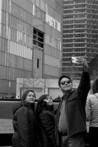 family taking photo in front of memorial