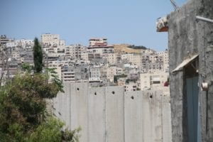 cement wall blocking a hilly landscape 