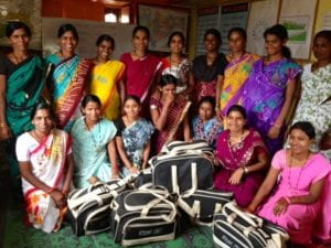 women posing with bags