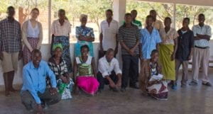 the author posing with community members