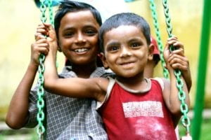 two boys on a swing