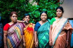 four women posing outside