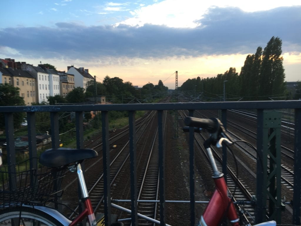 pedestrian bridge and bike above train tracks