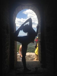 the author doing a yoga pose on the Great Wall of China