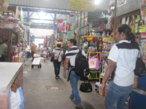 men walking through an indoor market