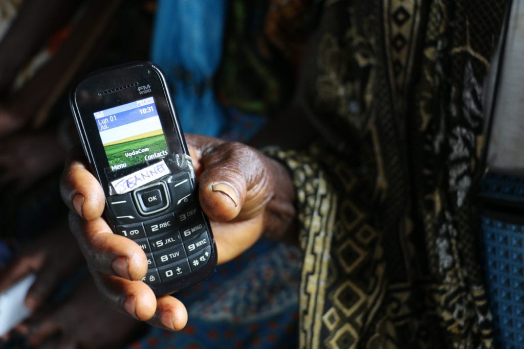 Older model phone held in women's hand