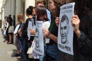 Protesters lined up holding english pen sign