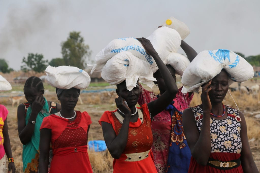 Women walking with the food ration on top of their heads