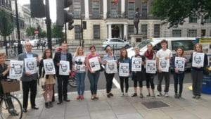 People standing in semi-circle holding signs for Liu Xiaobo