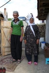 Husband and Wife standing side by side outside