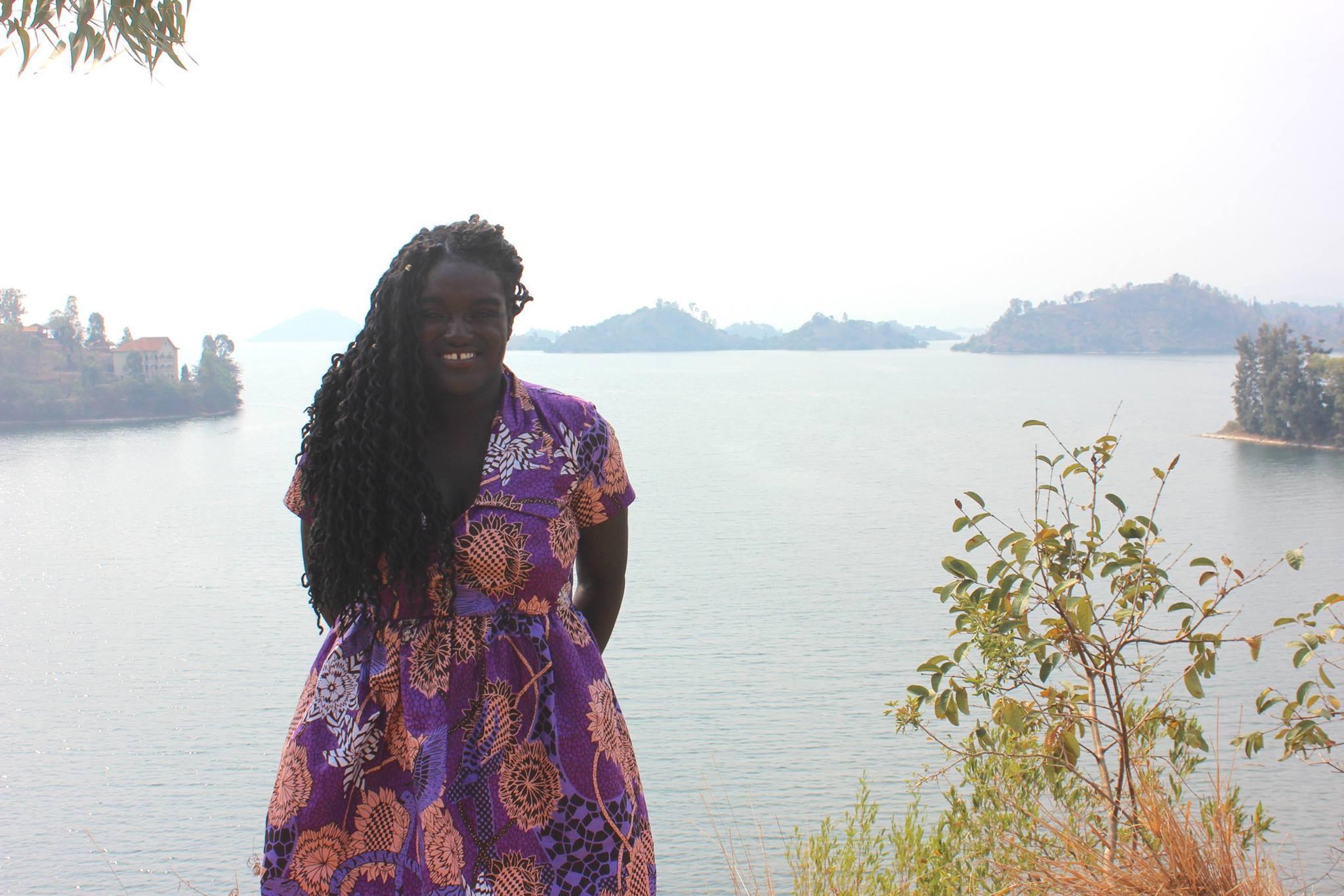 the author in front of a lake with mountains in the background