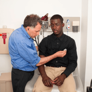 Dr. Keller examining a patient's heart in a examination room