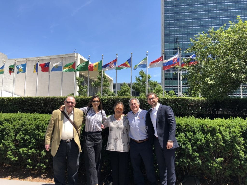 the author with a group of people outside UN building with flags