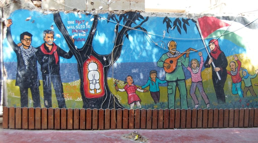 mural showing people playing music around a tree