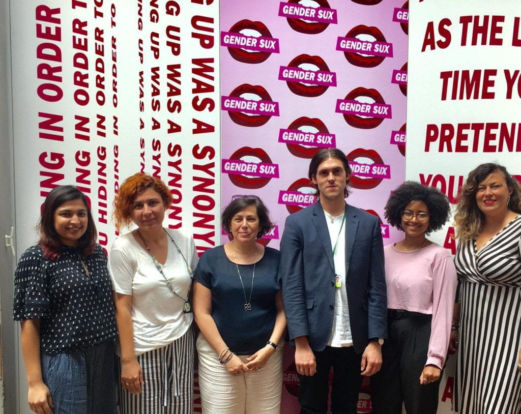 the author and people in front of large placards