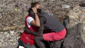 Red Cross volunteer Luna Reyes embraces a Senegalese migrant on the shore of Ceuta