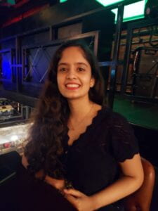 Image of Siri Pothuri - a South Asian Woman with mid-length dark brown hair wearing a black top.